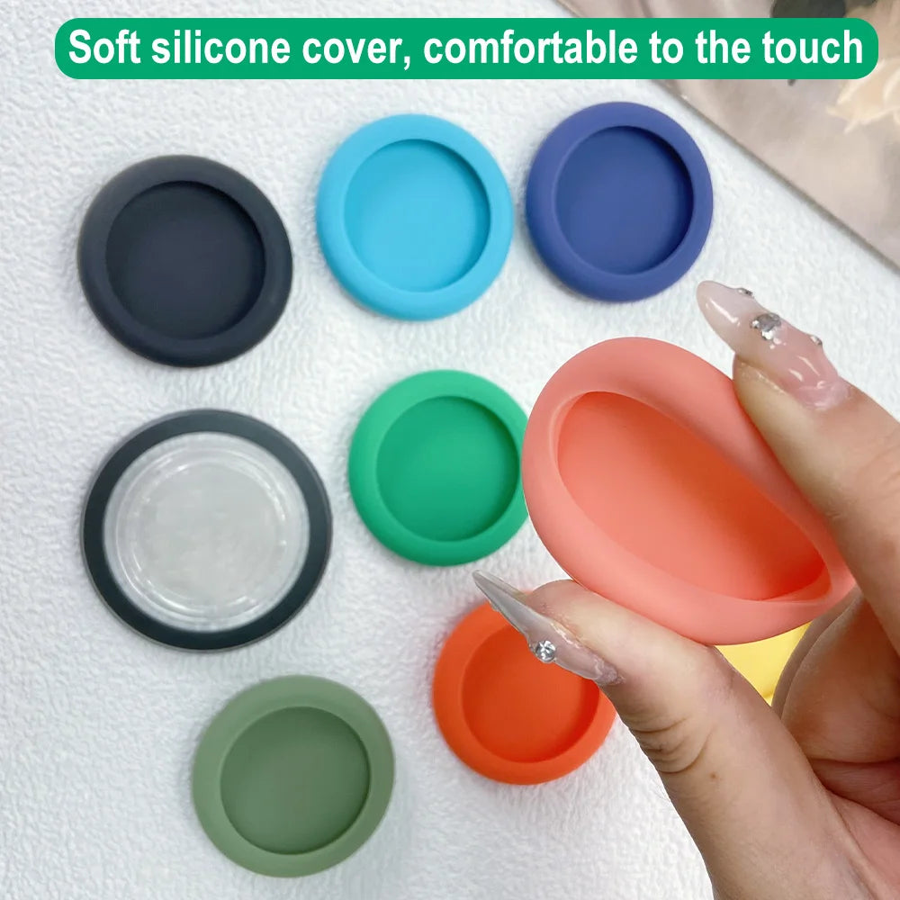 Various colored soft silicone covers for a phone grip stand shown on a white surface.