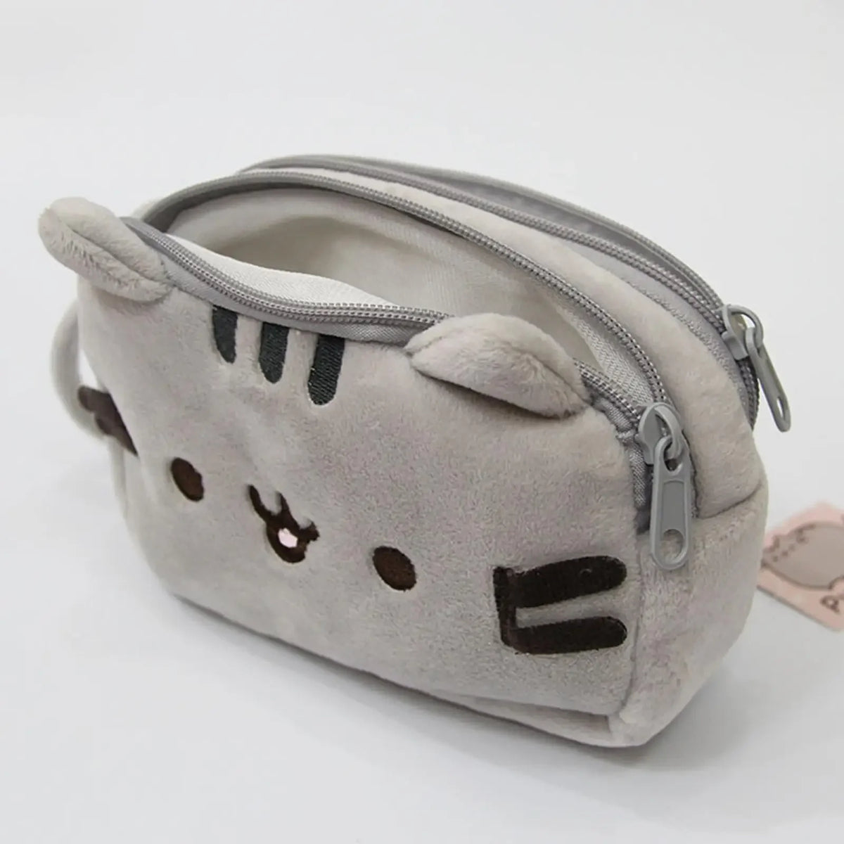A soft gray plush cat pencil case with a zipper and embroidered features.
