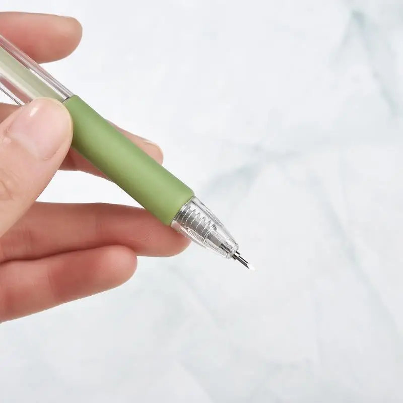 A hand holds a light green precision utility knife with a silver blade, poised for use.