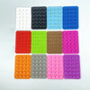 A grid of 12 silicone suction cups in various colors including white, black, light blue, green, brown, pink, orange, gray, an
