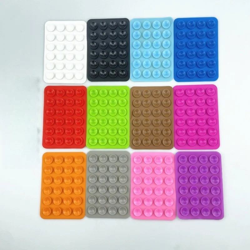 A grid of 12 silicone suction cups in various colors including white, black, light blue, green, brown, pink, orange, gray, an