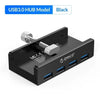 A black USB 3.0 hub with multiple ports and a clip is shown from above.