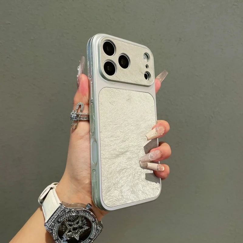 A hand holds a phone case with a frosted velvet texture and shockproof protection against a gray background.