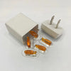 A white storage box with multiple gold-colored charger plugs for valuables.