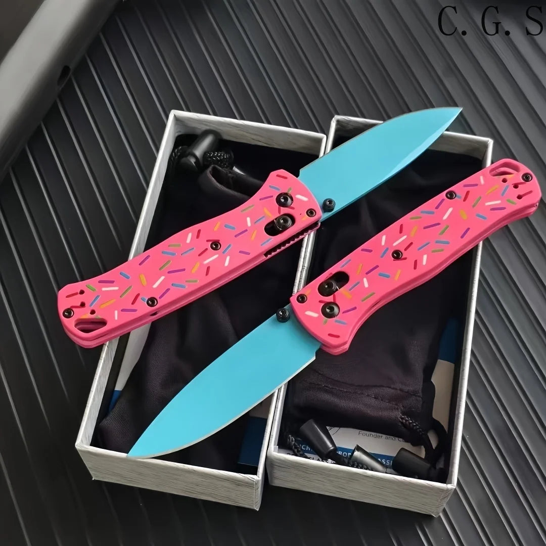 Pink donut acrylic folding knife with a blue steel blade displayed in a box.