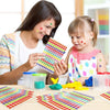 A woman is helping a young girl create colorful glitter foil star stickers for crafts and rewards.
