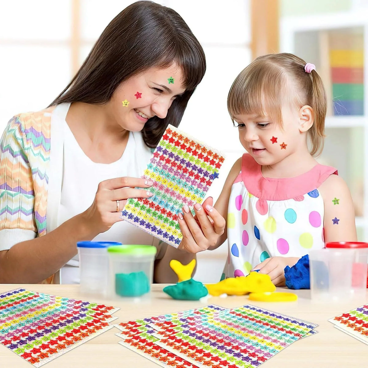 A woman is helping a young girl create colorful glitter foil star stickers for crafts and rewards.