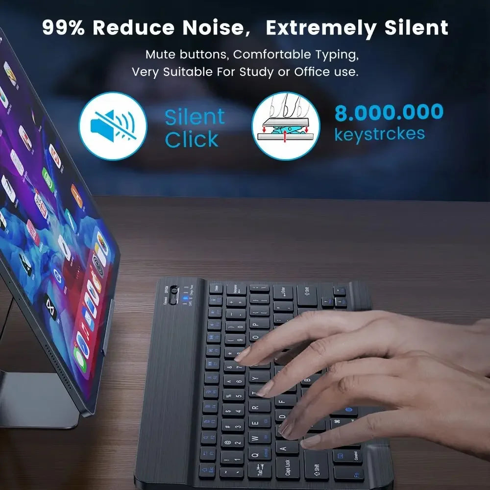 A hand is typing on a portable Bluetooth keyboard with a dark gray case, next to an iPad.