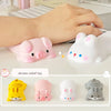 A collection of pink, white, and yellow kawaii ergonomic stress relief toys shaped like pigs and rabbits for mouse and keyboa