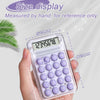 A hand holds a clear mini silent calculator displaying the number 12345678 on a gray background.