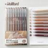 A set of nine brown and red ballpoint pens from Maillard, packaged in a clear plastic case.
