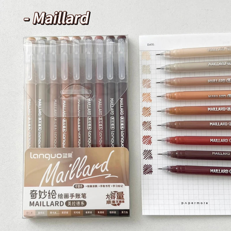 A set of nine brown and red ballpoint pens from Maillard, packaged in a clear plastic case.
