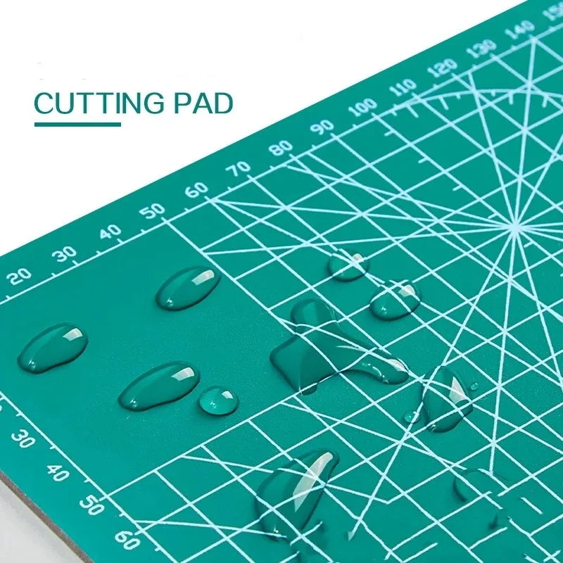 A green cutting pad with various clear, glossy blobs and markings visible on the surface.