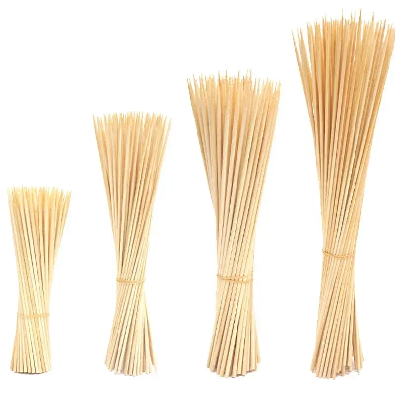 A set of natural bamboo skewers of various lengths arranged vertically.
