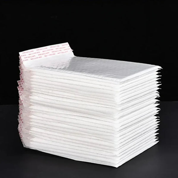 A stack of premium white padded mailers for shipping and gifts, packaged with a label.
