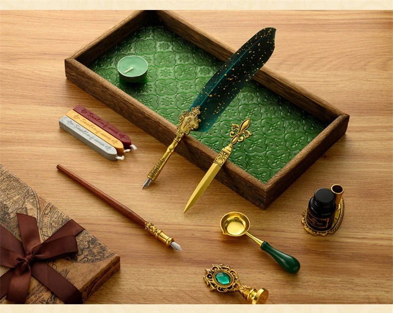A luxury fountain pen set with a dark green feather pen and gold accents displayed in a wooden box.