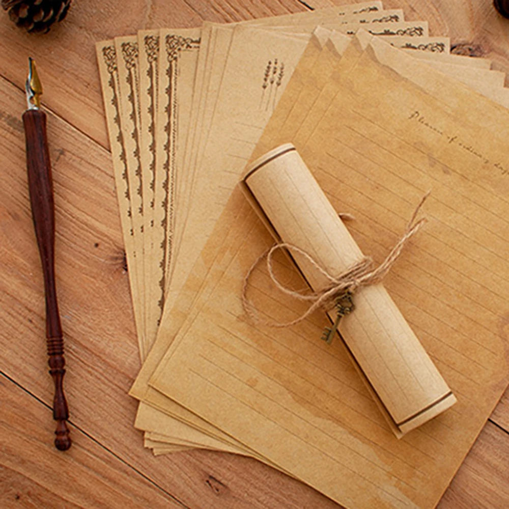 A stack of vintage European style letter and invitation envelopes made of light brown paper, with a rolled scroll tied with t