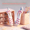 A pink healing unpacking assistant featuring a cat paw design, shown next to a storage box and scissors.
