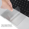A hand is applying a clear trackpad protector film to a laptop touchpad for easy application and removal.