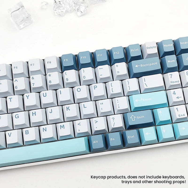 A close-up view of a set of light blue and gray PBT keycaps for mechanical keyboards.