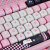 A pink and black cat print PBT keycap set for mechanical keyboards displayed in a plastic tray.