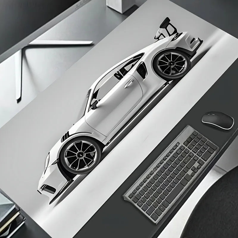 A white sports car model is displayed on a dark surface next to a gaming mousepad.
