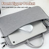 A gray front zipper pocket laptop sleeve holding a silver tablet or laptop.