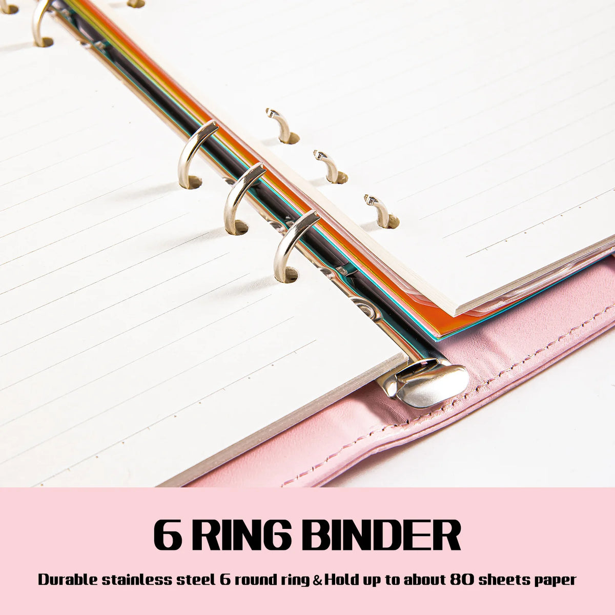 A close-up of a 6 ring binder with a pink PU leather cover and lined paper inside.