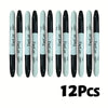 A set of twelve black permanent markers arranged in a row.