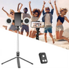 A selfie stick tripod is shown with a smartphone mounted, a light attachment, and a folding leg.