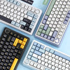 A collection of various mechanical keyboards in Glacier Blue, Cedar Green, and blue tones shown from above.
