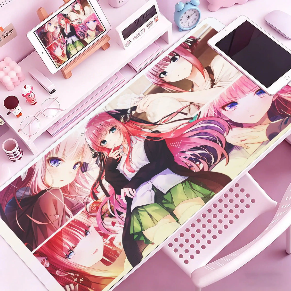A pink and purple anime-themed mouse pad and desk mat featuring characters on a white surface.
