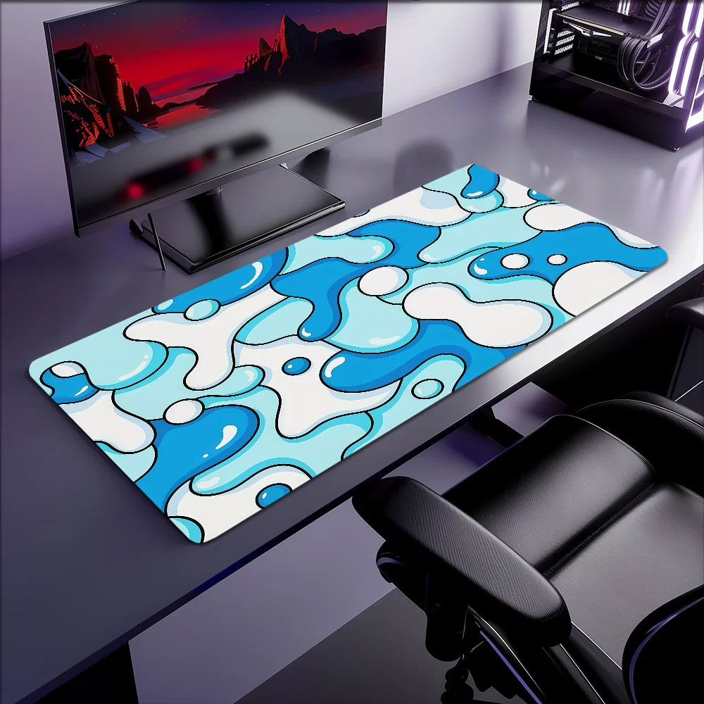 A blue wave art non-slip mouse pad with a lockedge is displayed on a dark desk next to a computer monitor.
