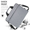 A gray shockproof laptop sleeve bag is shown with a black strap, featuring a protective design.