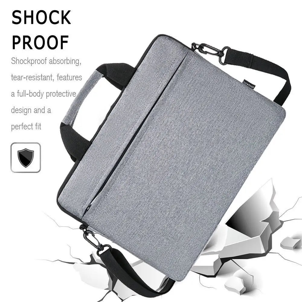 A gray shockproof laptop sleeve bag is shown with a black strap, featuring a protective design.