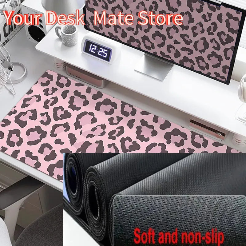 A black desk mat with a leopard print design is shown next to a digital clock and other office supplies.