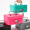 A pink steel cash box with a key lock and removable tray is shown being handled.