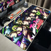 An anime-inspired gaming mouse pad featuring characters from JoJo's Bizarre Adventure on a desk.