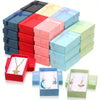A stack of 24 colorful jewelry gift boxes in various shades of red, pink, blue, and green.