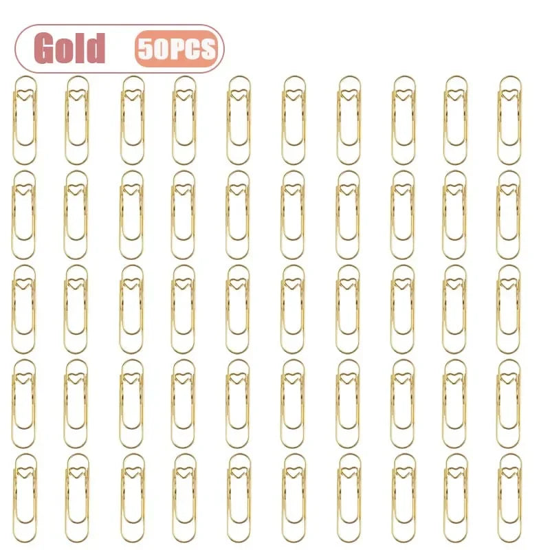 A set of gold metal pen clips for notebooks and journals.