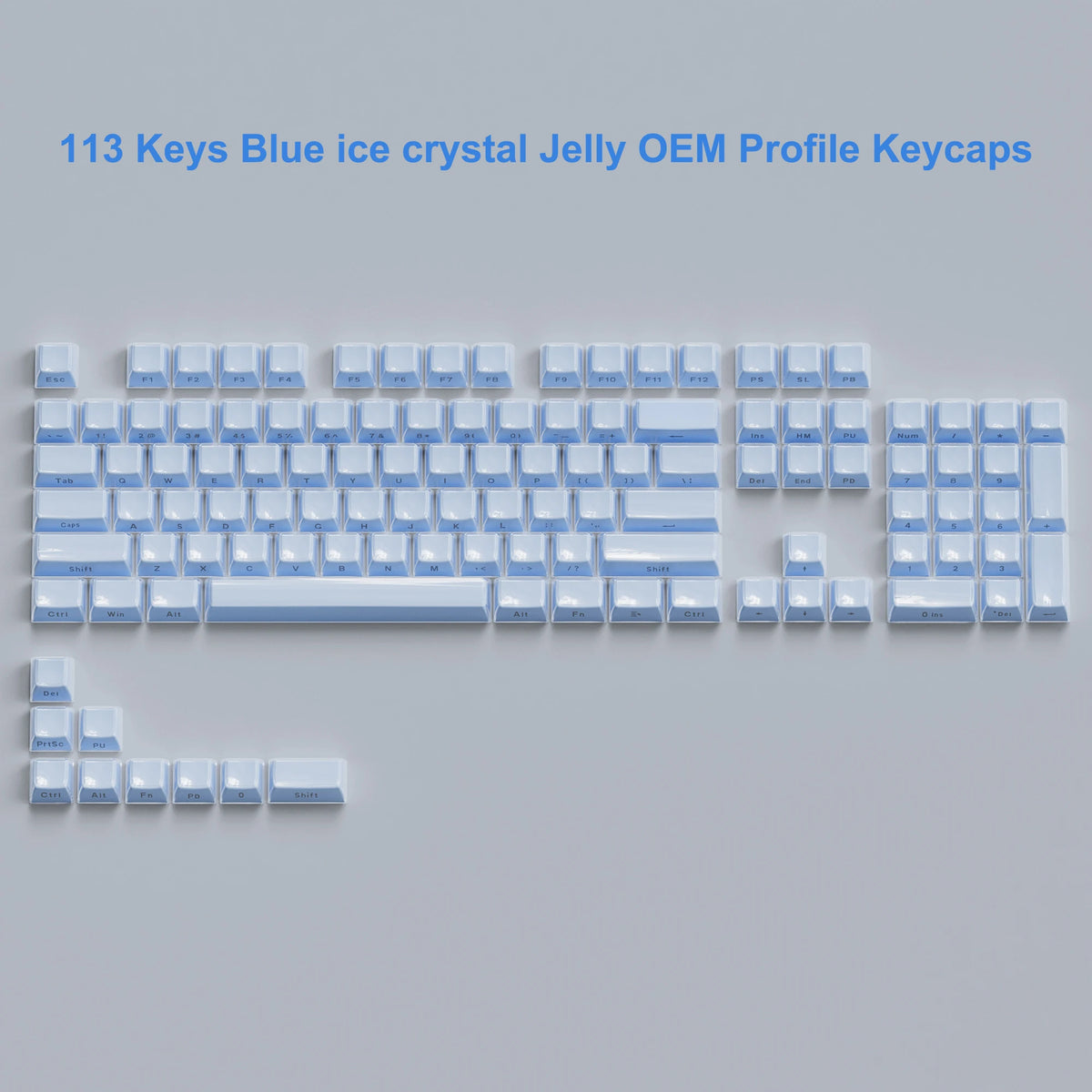 A collection of 113 blue ice crystal jelly OEM profile keycaps laid out on a surface.