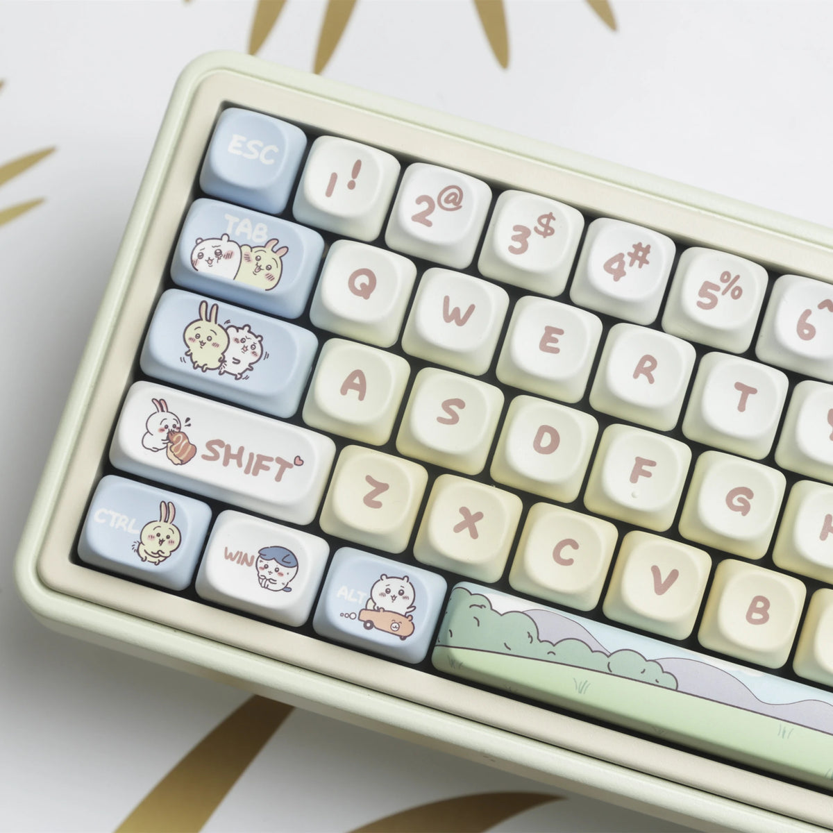 A close-up view of light beige dye-sublimated PBT keycaps for a mechanical keyboard, showing various letter and function keys