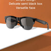 A pair of semi black sunglasses resting on a white surface with an orange background.