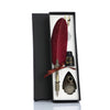A black gift box contains a set of retro calligraphy feather dip pens, including a red feather and a metal nib.