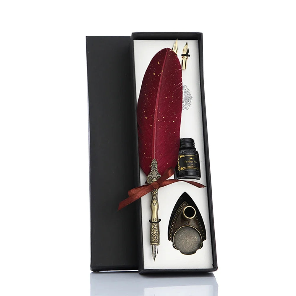 A black gift box contains a set of retro calligraphy feather dip pens, including a red feather and a metal nib.