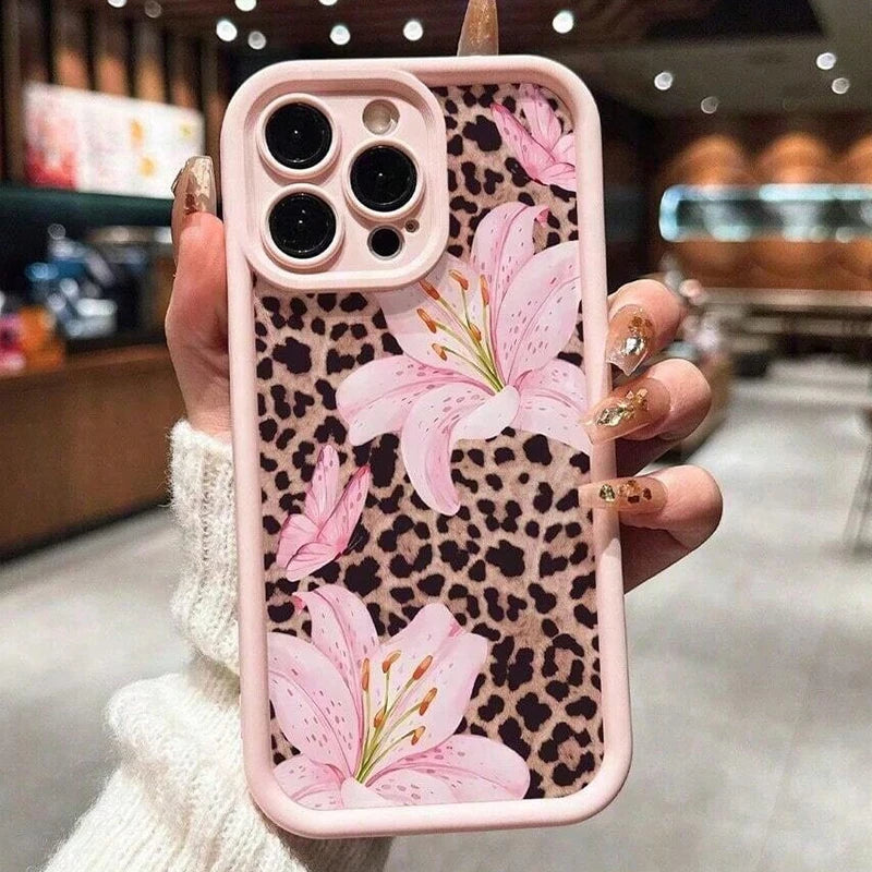 A pink leopard print phone case featuring large pink lily floral designs for an iPhone.
