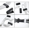 A set of black cable organizers and clips for managing wires on desks and electronics.