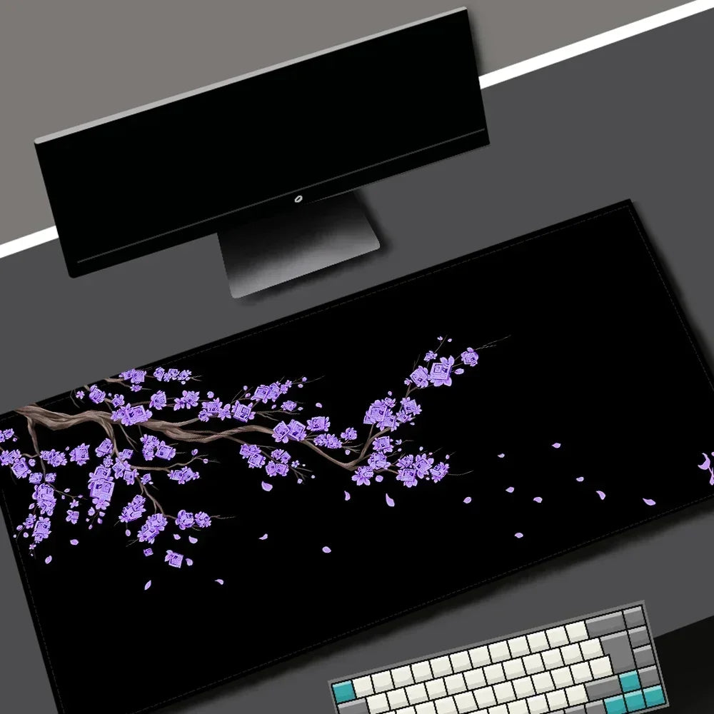 A black gaming mouse pad featuring a purple cherry blossom design and a white keyboard.