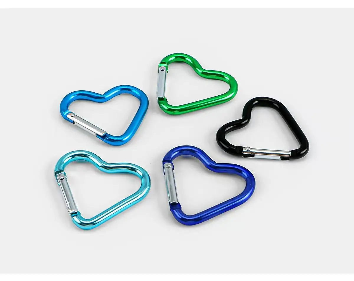 A collection of five colorful heart-shaped spring clasps and carabiner keychains in blue, green, and black.