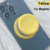 Yellow MagSafe phone grip stand with silicone cover shown on a dark blue smartphone.